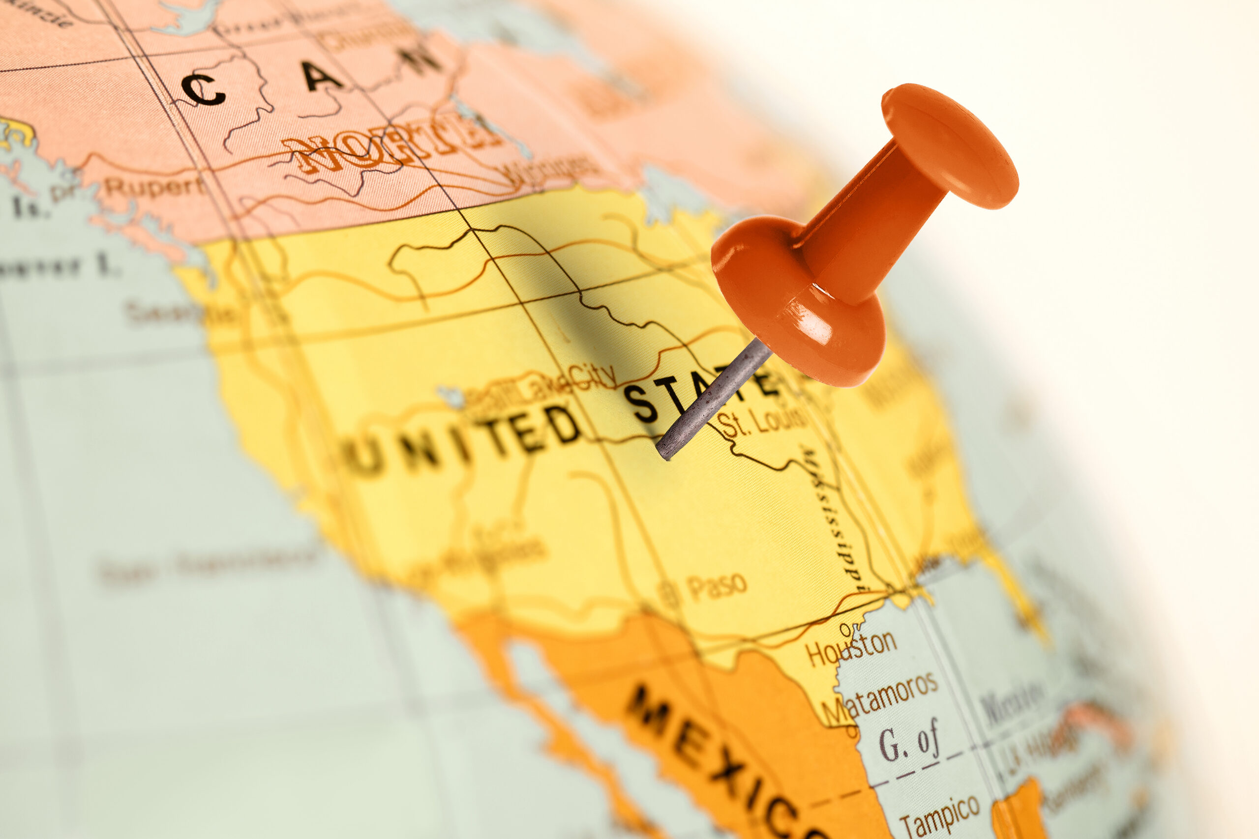 Pushpin marking a location on a map of the United States, highlighting cross-state connections.