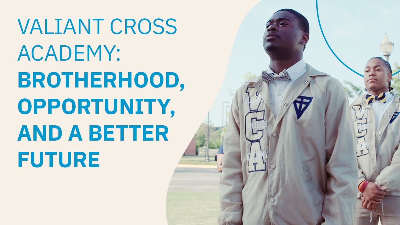 Two students wearing Valiant Cross Academy jackets stand confidently outdoors beside text reading: “Valiant Cross Academy: Brotherhood, Opportunity, and a Better Future."
