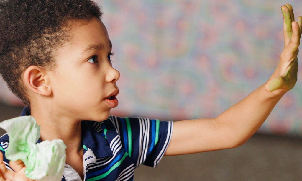 Donovan engaged in a small classroom activity at his new school